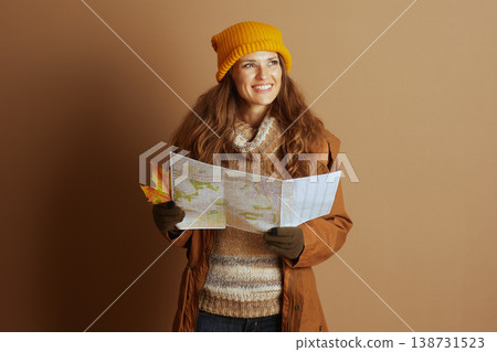 Woman Navigator with Open Map and Autumn Leaf 138731523