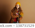 Happy Hiker with Autumn Leaves and Walking Stick 138731529