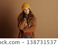 Woman Ponders, Hand on Chin in Winter Jacket 138731537