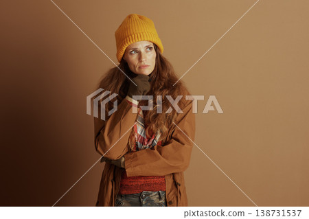 Woman Ponders, Hand on Chin in Winter Jacket Woman Ponders, Hand on Chin in Winter Jacket 138731537
