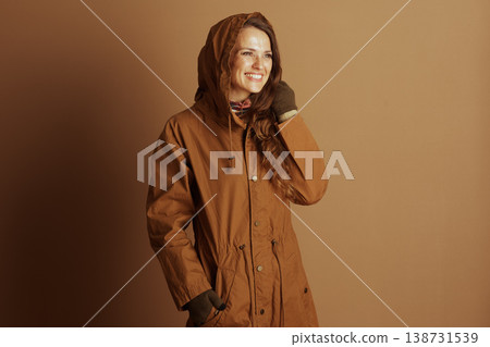 Cheerful Woman in Autumn Jacket, Hand on Face Cheerful Woman in Autumn Jacket, Hand on Face 138731539