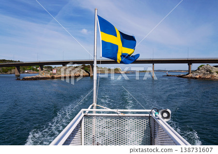 Swedish flag on ferry near bridge between Styrso and Donso islands of Gothenburg archipelago, Gothenburg Minucipality, Vastra Gotaland County, Sweden, sunny day Swedish flag on ferry near bridge between Styrso and Donso islands of Gothenburg archipelago, Gothenburg Minucipality, Vastra Gotaland County, Sweden, sunny day 138731607