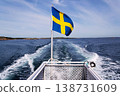 Swedish flag on ferry near bridge between Styrso and Donso islands of Gothenburg archipelago, Gothenburg Minucipality, Vastra Gotaland County, Sweden, sunny day 138731609