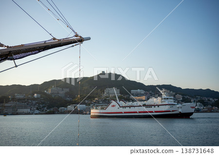 A white ferry sailing through a port town 138731648