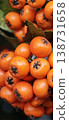 Macro photography of Pyracantha berries and green leaf. 138731658