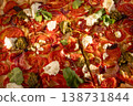 Delicious homemade pizza with tomatoes, ricotta, pesto and coriander is cut into square slices 138731844
