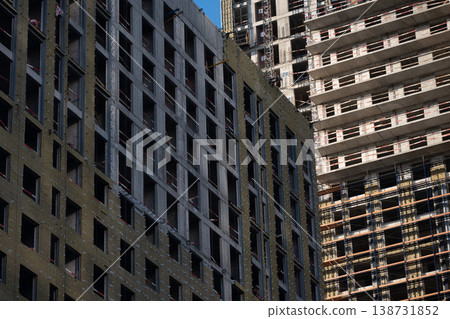 Construction workers building new apartment buildings in a developing urban area 138731852