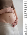 Pregnant woman holding her belly with love and care 138731854