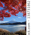 Mount Fuji rising above lake Kawaguchiko framed by autumn maple 138731862