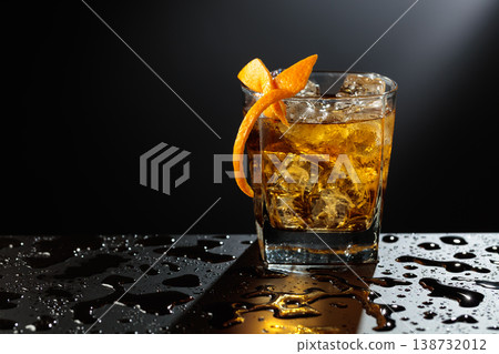 Old fashioned cocktail on a wet black table. 138732012