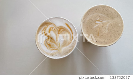 Top view of two cups of fresh latte with heart shaped foam art on a clean white minimalist background Top view of two cups of fresh latte with heart shaped foam art on a clean white minimalist background 138732057