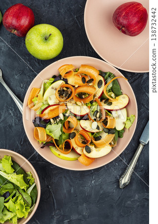 Healthy raw salad with apple slices carrot ribbons and seeds 138732442