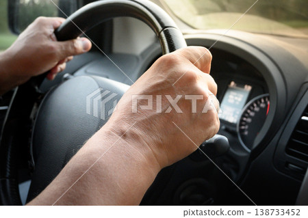 Hands on steering wheel driving car close up transport concept Hands on steering wheel driving car close up transport concept 138733452
