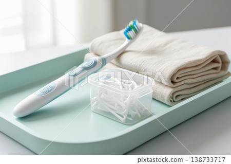 Electric toothbrush mockup on mint tray with floss picks and folded towel 138733717