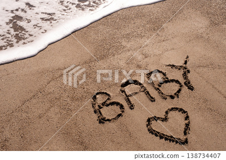 Baby writ on a sand. Baby written in the sand on the beach. Baby writ on a sand. Baby written in the sand on the beach. 138734407