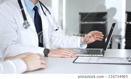 Doctor man using digital tablet in medical office, browsing patient information for diagnosis and modern healthcare solutions. Medicine, healthcare and science concept Doctor man using digital tablet in medical office, browsing patient information for diagnosis and modern healthcare solutions. Medicine, healthcare and science concept 138734965