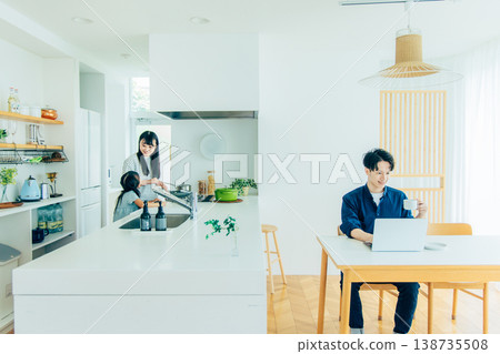 A young man working remotely and his family A young man working remotely and his family 138735508