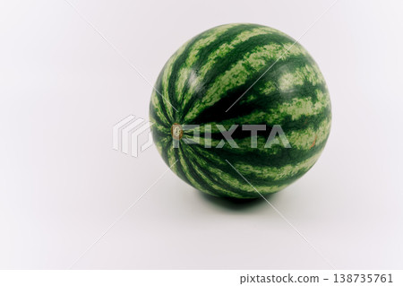 A whole, fresh watermelon placed against a white background. 138735761