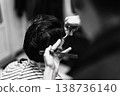 Intimate Barbershop Setting With Skilled Technician Shaping Hair Meticulously In Monochrome Tone 138736140