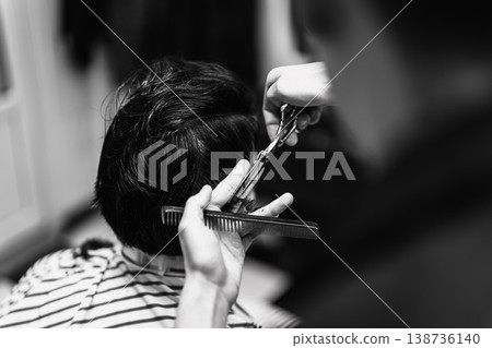 Intimate Barbershop Setting With Skilled Technician Shaping Hair Meticulously In Monochrome Tone 138736140