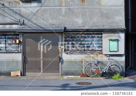 A scene with a bicycle in what is now an abandoned building, somehow evoking a sense of nostalgia. A scene with a bicycle in what is now an abandoned building, somehow evoking a sense of nostalgia. 138736181