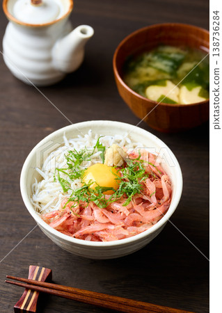 Two-color rice bowl with raw sakura shrimp and boiled whitebait, topped with a raw egg. Two-color rice bowl with raw sakura shrimp and boiled whitebait, topped with a raw egg. 138736284