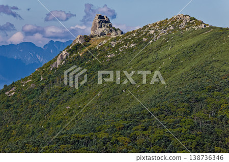 The Gojo-ishi rock formation at the summit of Mt. Kinpu as seen from Mt. Asahi in Okuchichibu. The Gojo-ishi rock formation at the summit of Mt. Kinpu as seen from Mt. Asahi in Okuchichibu. 138736346