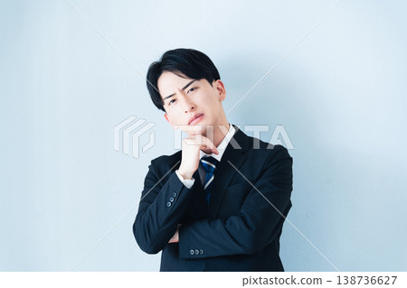 A businessman who thinks with arms A businessman who thinks with arms 138736627