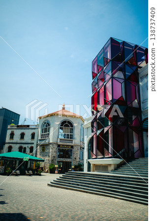 The modern building's exterior features colorful stained glass. 138737409