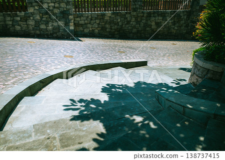 The texture of sunlight filtering through the trees and the shadows of the trees reflected on the cobblestone steps. The texture of sunlight filtering through the trees and the shadows of the trees reflected on the cobblestone steps. 138737415