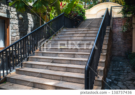 A garden with stone steps and black railings. For architecture and landscaping. A garden with stone steps and black railings. For architecture and landscaping. 138737436