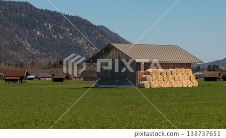 Hay Bales Beside Wooden Barn in Open Meadow 138737651