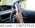 Asian woman driver hold cold water for drink in car, dangerous and risk an accident. 138737918
