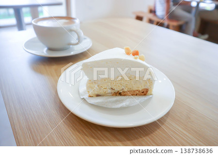coconut tart or coconut cake or sponge cakeor coconut tart with macadamia and hot coffee coconut tart or coconut cake or sponge cakeor coconut tart with macadamia and hot coffee 138738636
