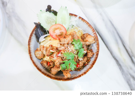 deep fried pork , fried pork or stir fried pork with fried garlic and chili topping deep fried pork , fried pork or stir fried pork with fried garlic and chili topping 138738640