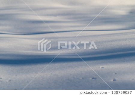 Snow shadows sparkle. Detailed view of snow with glittering shadows under winter sun. Closeup of snow showcasing contrasting shadows and sparkling effects in winter sunlight Snow shadows sparkle. Detailed view of snow with glittering shadows under winter sun. Closeup of snow showcasing contrasting shadows and sparkling effects in winter sunlight 138739027