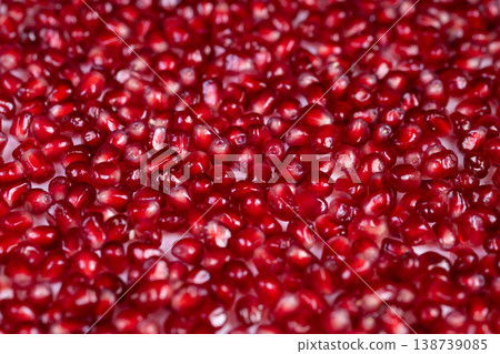 Soft focus highlights shimmering seed surface. Romantic still life capturing sparkle of seeds. Closeup shot emphasizing sensual gloss and delicate glow of pomegranate seeds 138739085