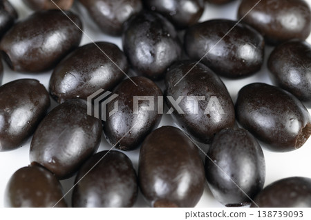 Magnified view of olive skin patterns and shine. Highresolution macro photograph capturing textures and reflections on olive skins with background focus emphasis Magnified view of olive skin patterns and shine. Highresolution macro photograph capturing textures and reflections on olive skins with background focus emphasis 138739093