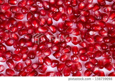 Bright display of pomegranate seeds. Lively arrangement of juicy pomegranate seeds. An eyecatching display showcasing vibrant and juicy seeds inside pomegranate fruit Bright display of pomegranate seeds. Lively arrangement of juicy pomegranate seeds. An eyecatching display showcasing vibrant and juicy seeds inside pomegranate fruit 138739098