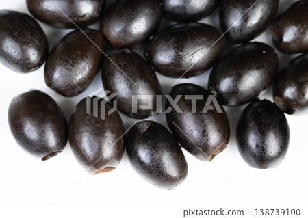 Clean layout showcasing black olives against bright background for branding. Minimalist arrangement of black olives on white to highlight for marketing and packaging purposes 138739100
