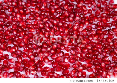 Vivid fruit closeup. Closeup image showcasing glossy red pomegranate arils in detail. Vibrant and detailed macro photograph highlighting shiny red pomegranate seeds Vivid fruit closeup. Closeup image showcasing glossy red pomegranate arils in detail. Vibrant and detailed macro photograph highlighting shiny red pomegranate seeds 138739106