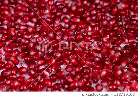 Colorful seeds emphasize health benefits. Lustrous pomegranate seeds showcase dietary richness. Detailed depiction of seeds illustrating wellness and nourishment qualities 138739108