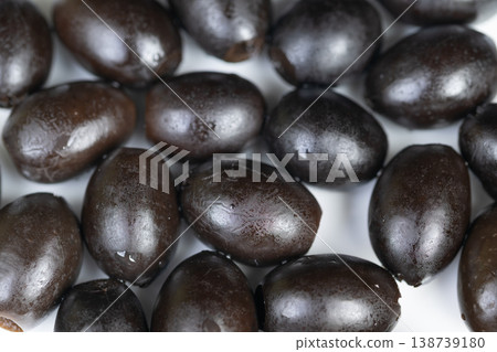 Marinated olives in rustic dish. Herbinfused black olives in Mediterranean style. Black olives seasoned with herbs served in rustic bowl for salads and antipasto Marinated olives in rustic dish. Herbinfused black olives in Mediterranean style. Black olives seasoned with herbs served in rustic bowl for salads and antipasto 138739180