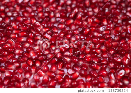 Superfood pomegranate seeds emphasizing health benefits with soft lighting. Bright and translucent pomegranate seeds showcasing antioxidants for health and diet content 138739224