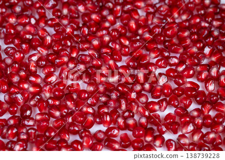 Garnished pomegranate seeds. Vivid garnishes ideal for meals and celebrations. Bright red pomegranate seeds enhance presentation in culinary creations and festive displays 138739228