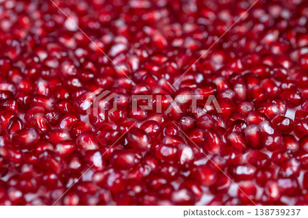 Artistic portrayal emphasizing glossy surface of pomegranate seeds with dew. Vivid visual representation focusing on shimmering dew drops adorning vibrant pomegranate seeds Artistic portrayal emphasizing glossy surface of pomegranate seeds with dew. Vivid visual representation focusing on shimmering dew drops adorning vibrant pomegranate seeds 138739237