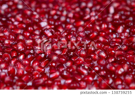 Festive ruby adornments. Seasonal holiday decorations with vibrant arils shine. Festive pomegranate seeds with reflective highlights enhance seasonal dinner table decor 138739255