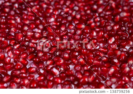 Colorful pomegranate seeds serve as elegant food decoration elements. Decorative bright pomegranate seeds used to embellish and highlight culinary creations visually 138739256
