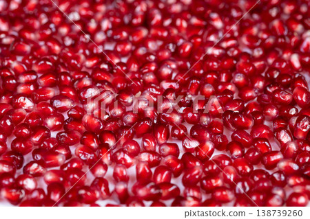 Vivid ruby seeds. Crimson berry seeds cascade vividly across surface. Richly colored pomegranate seeds resemble plush ruby carpet brimming with seasonal harvest abundance Vivid ruby seeds. Crimson berry seeds cascade vividly across surface. Richly colored pomegranate seeds resemble plush ruby carpet brimming with seasonal harvest abundance 138739260
