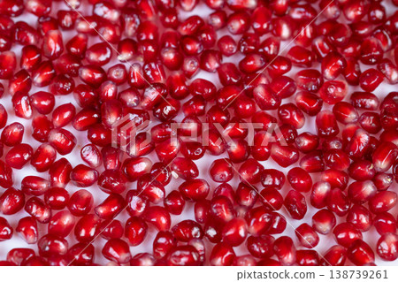 Sparkling berries with dewy allure. Closeup of shiny pomegranate seeds under gentle light. Intimate view of vibrant berries with shimmering dew and enticing glow Sparkling berries with dewy allure. Closeup of shiny pomegranate seeds under gentle light. Intimate view of vibrant berries with shimmering dew and enticing glow 138739261